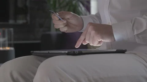 Man online shopping on tablet computer and pays with his credit card Stock Footage 68458899