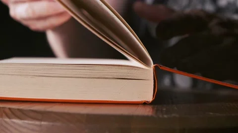 Man open the book and slowly turns the pages of the book Stock Footage 156679662
