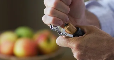 Man open champagne bottle with cork opener Stock Footage 101201007