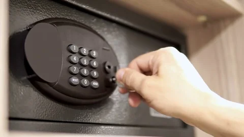 Man open code safe in hotel room with key 스톡 동영상 76329239