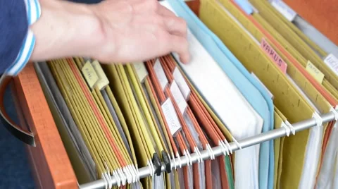 Man open the drawer and look for in folder - detail of hand Stock Footage 62314157