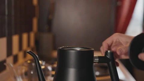 Man open the lid of a boiling kettle with steam Stock Footage 294253759