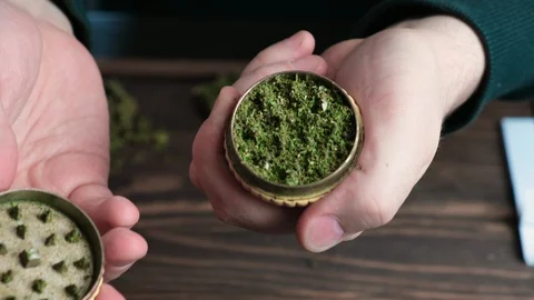 Man open marijuana grinder to show that it full of grinded cannabis. Stock Footage 128071355
