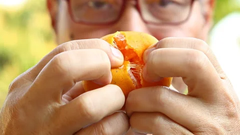 Man open orange , out door  Chiangmai  Thailand Stock Footage 145865016