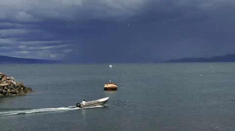 Man in Open Skiff Heading Out on Bay Storm Brewing Stock Footage 11199027