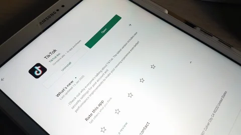 A man open Tiktok app from Google App Store on A Tablet Usa 2019 Stock Footage 123075856
