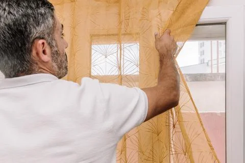 Man Open Window for Fresh Air And Cool Home In Summer Heat, house burping tre Stock Photos