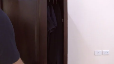 The Man opened the closet with clothes Stock Footage 82679498