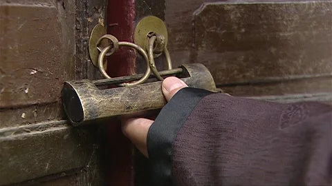 The man opened the door lock of the house during the day Stock Footage 276516621