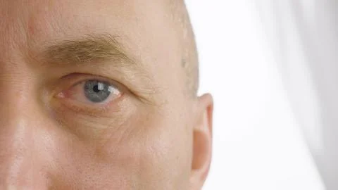 Man with opened eyes blinking close up. Vision, eyesight, ophthalmology Stock Photos