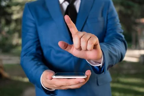 Man with opened hands stands in suite. Concept with copy space and man Stock Photos