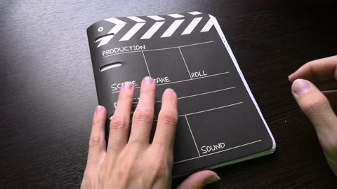 The man opened the notebook and after he closes it and puts it back in its place Stock Footage 160555762