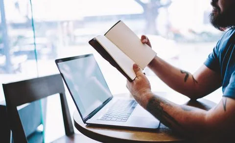 Man with opened notebook and laptop Stock Photos