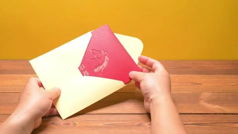 Man opening a 3D gift card of a horse on red background at horizontal Stock Footage 323440637