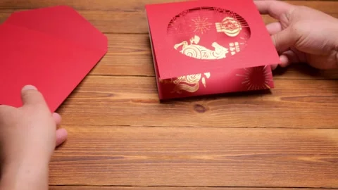 Man opening a 3D gift card of a horse on red background at horizontal Video stock 328825368