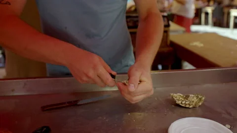Man opening and preparing fresh pysters in street food market in catania Stock Footage 233747571