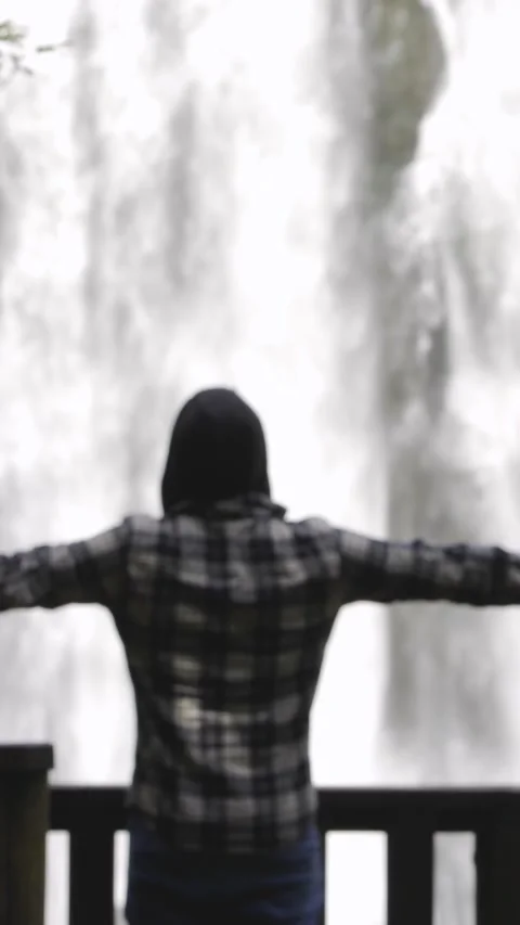 Man opening arms while admiring big hidden waterfall in the forest. Out-of-.. Stock Footage 290128638