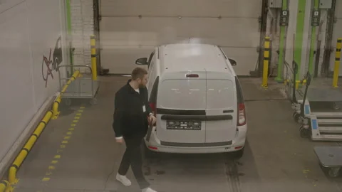 Man Opening Back Doors of Delivery Van in Self Storage Warehouse Stock Footage 340283245