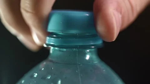 Man opening blue plastic water bottle cap. close up shot. Stock Footage 168950167