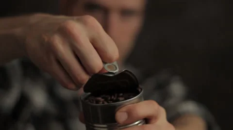 Man opening can of coffee beans Slow Motion Stock Footage 30460941