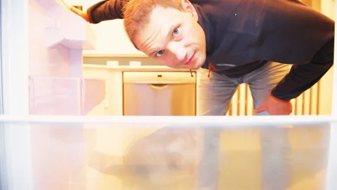 Man opening closing empty shelf fridge refrigerator white door at home kitchen Stock-Footage 164666471