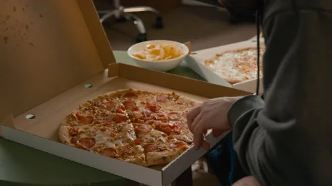 Man Opening Delivery Pizza Box and Checking Receipt while Sharing with Friends Stock Footage 336619236