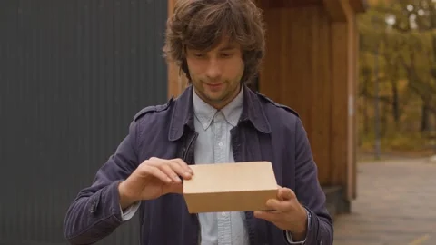 Man opening a disposable lunch box Stock Footage 141285491