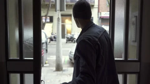 Man opening the door and going outside from building Stock Footage 132055608