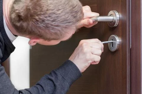 Man opening door with key Stock Photos