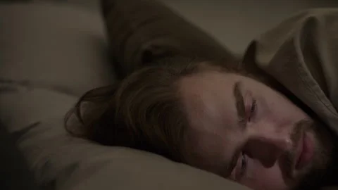 Man Opening Eyes in Bed Suffering from Sleep Deprivation Stock Footage 345514463