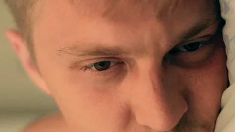 Man opening eyes in close-up 스톡 동영상 77876795