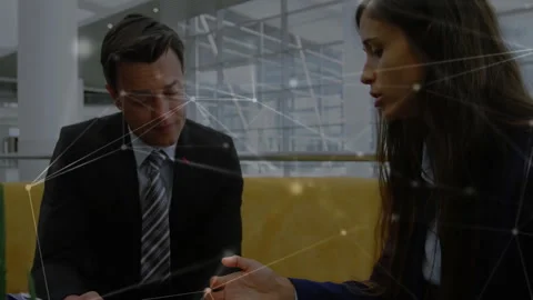 Man opening file reviewing and signing document with woman pointing clause in Stock Footage 313308078