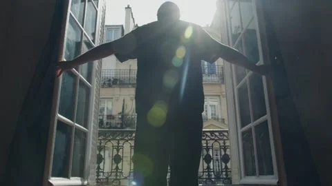 Man opening french window in paris apartment, welcoming new day Stock Footage 306673228