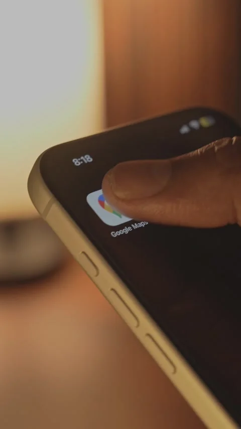 A man opening google maps app on a smartphone against an ambient background Stock Footage 333292534