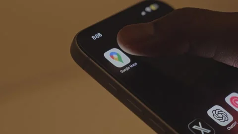 A man opening Google Maps app on a smartphone against an ambient background Stock Footage 333292668