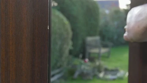 Man opening a ground floor window onto a garden / yard. Video stock 143099462