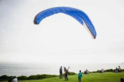 Man opening his paraglider Stock Photos