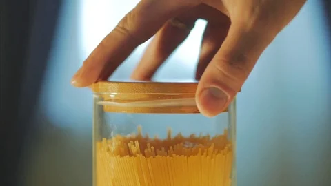 Man opening jar with spaghetti before cooking Stock Footage