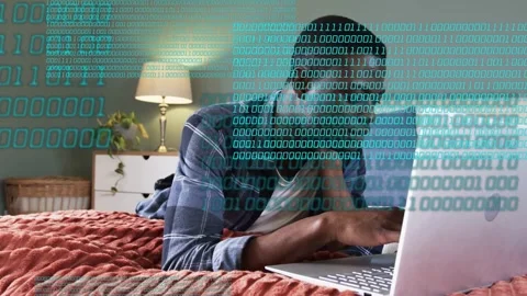 Man opening laptop in bed reading and typing while binary overlay growing Stock Footage 333278547