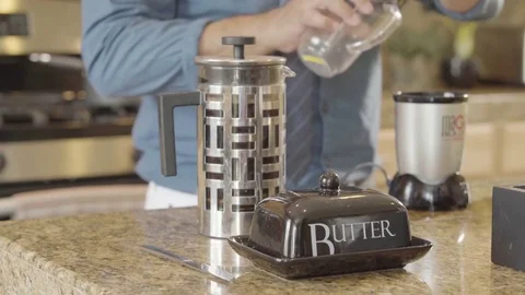 Man opening the lid of a coffee mug in the kitchen Stock Footage 83186246