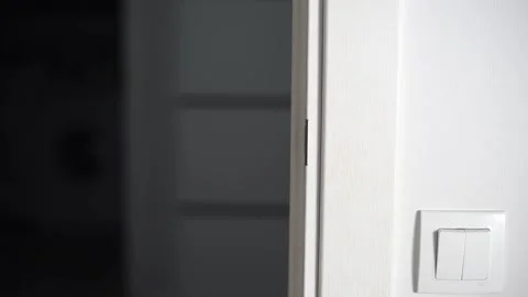 Man opening modern white door with metallic handle Stock Footage 293670964
