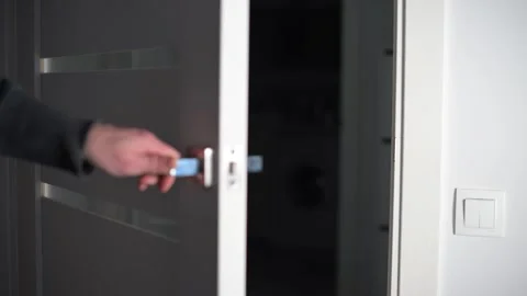 Man opening modern white door with metallic handle Stock Footage 293670965