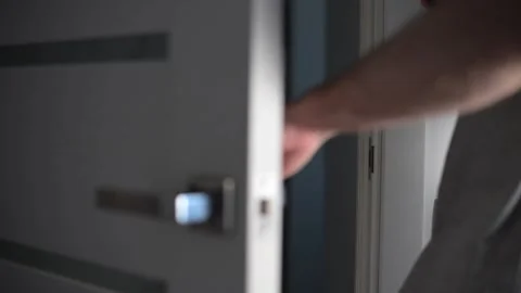 Man opening modern white door with metallic handle Stock Footage 293670975