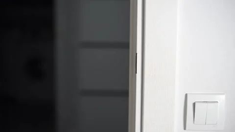 Man opening modern white door with metallic handle Stock Footage 293670980