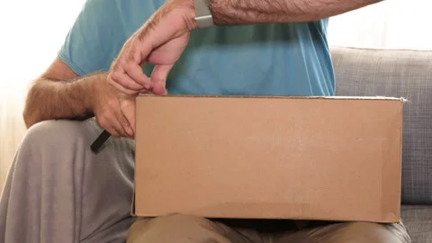 Man Opening Nike Box with Running Clothes Inside Stock Footage 304620138
