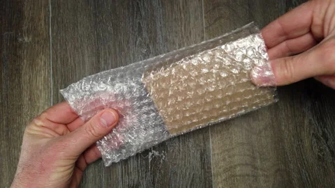 Man opening package from plastic packaging bag with balls Stock Footage 171640138