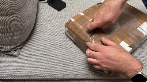 Man Opening Parcel With Cutter Overhead View Stock Footage 306050684