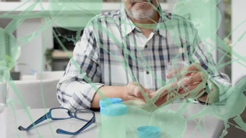 Man opening pill bottle pouring meds into palm gauging dose for health green web Stock Footage 337579215
