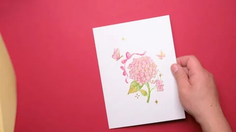 Man opening a pink 3D gift card with lots of beautiful butterflies Stock Footage 296972765