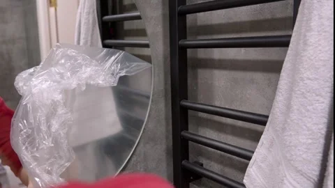 Man Opening Plastic Bag In Front Of Bathroom Mirror Stock Footage 304118433